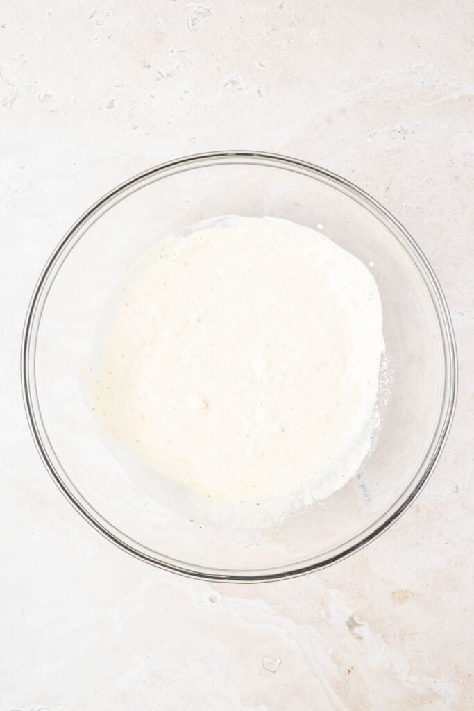 Creamy Greek yogurt, coleslaw dressing in a mixing ball