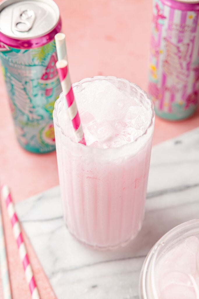 DIRTY ALANI IN A CUP WITH CANS OF ALANI AROUND IT