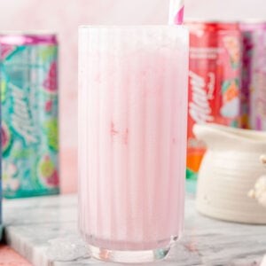 DIRTY ALANI IN A CUP WITH CANS OF ALANI AROUND IT AND A OF COFFEE CREAMER