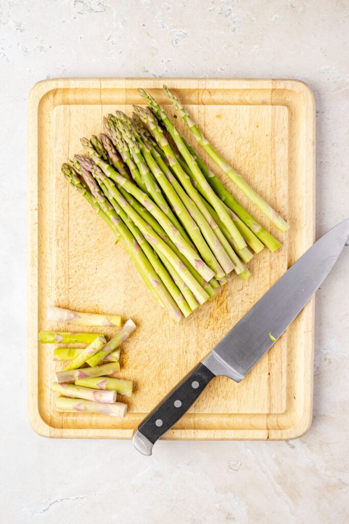 Asparagus on a cutting board with the ends trimmed off