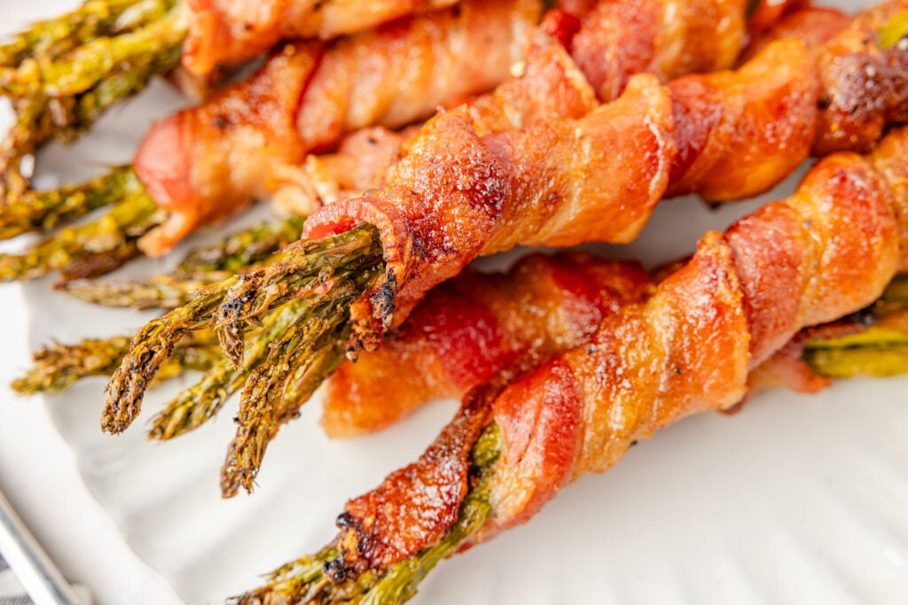 A plate of bacon wrapped asparagus up close