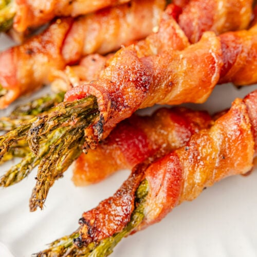 A plate of bacon wrapped asparagus up close