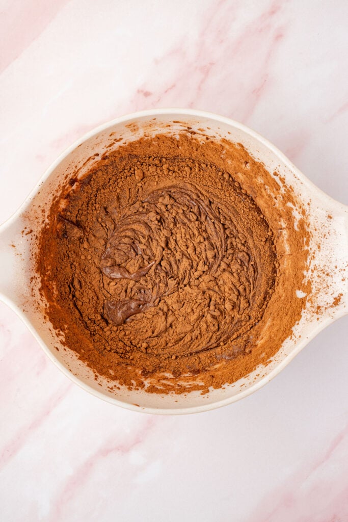 Cocoa powder added to powdered sugar and country cock mixture