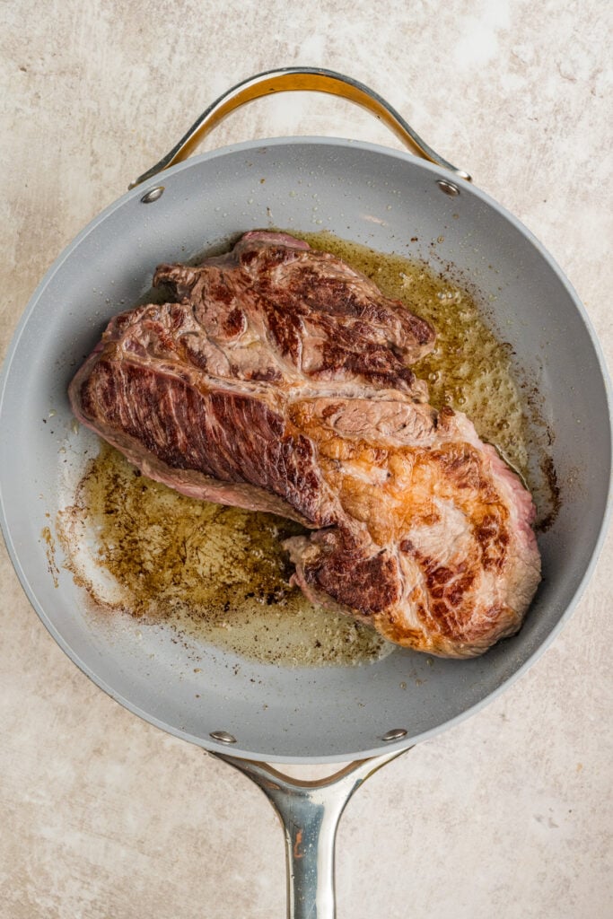 Sear chuck roast in a pan
