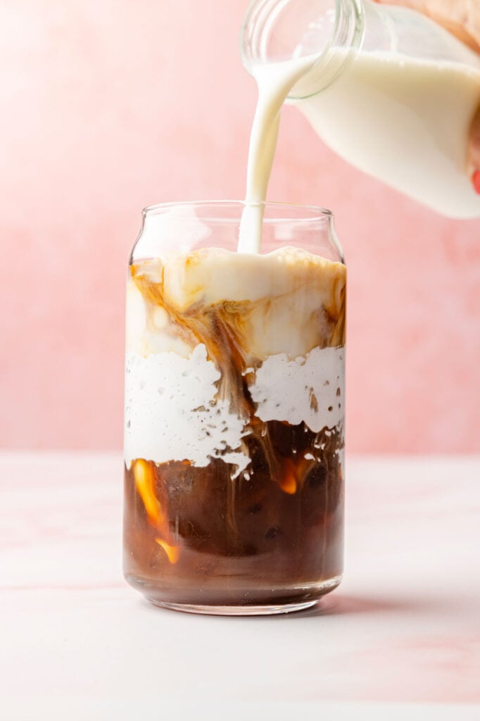 Adding milk to a cup with marshmallow fluff