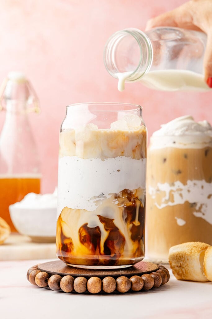 milk dripping into Toasted Marshmallow Iced Latte