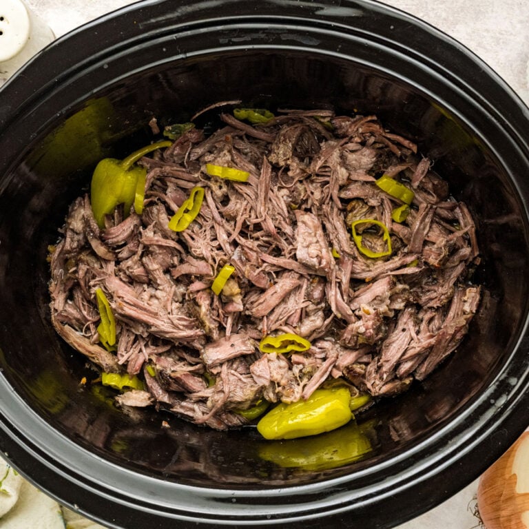 Tender shredded Italian beef soaked in rich savory broth in slow cooker