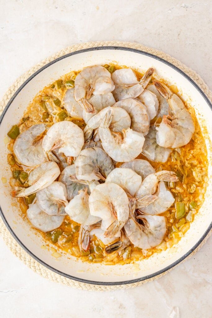 Cajun butter sauce in a pan with raw shrimp