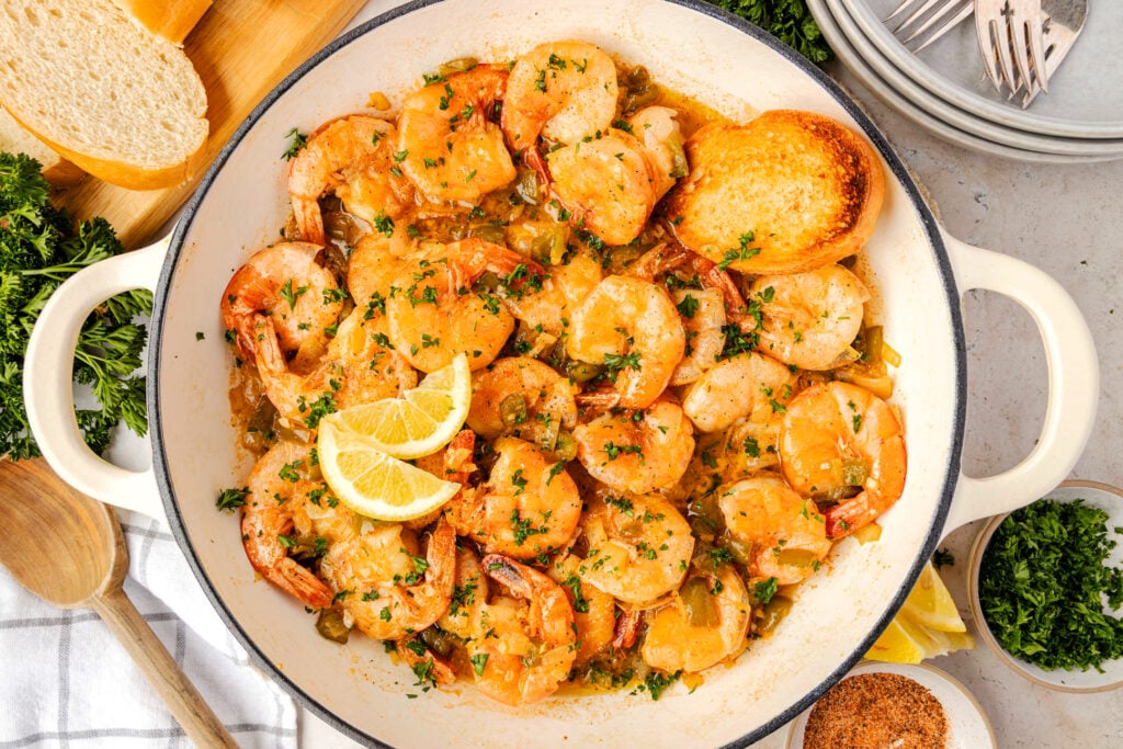 Pan of barbecue shrimp with lemons and bread