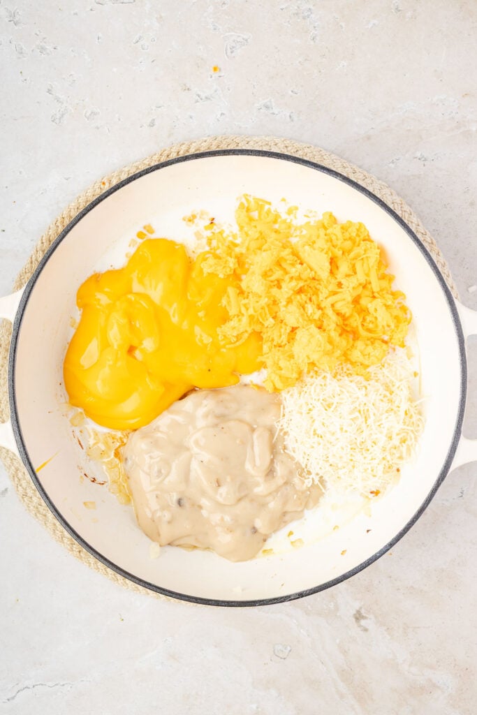Cream of soups, cheese, cooked onions in a pan