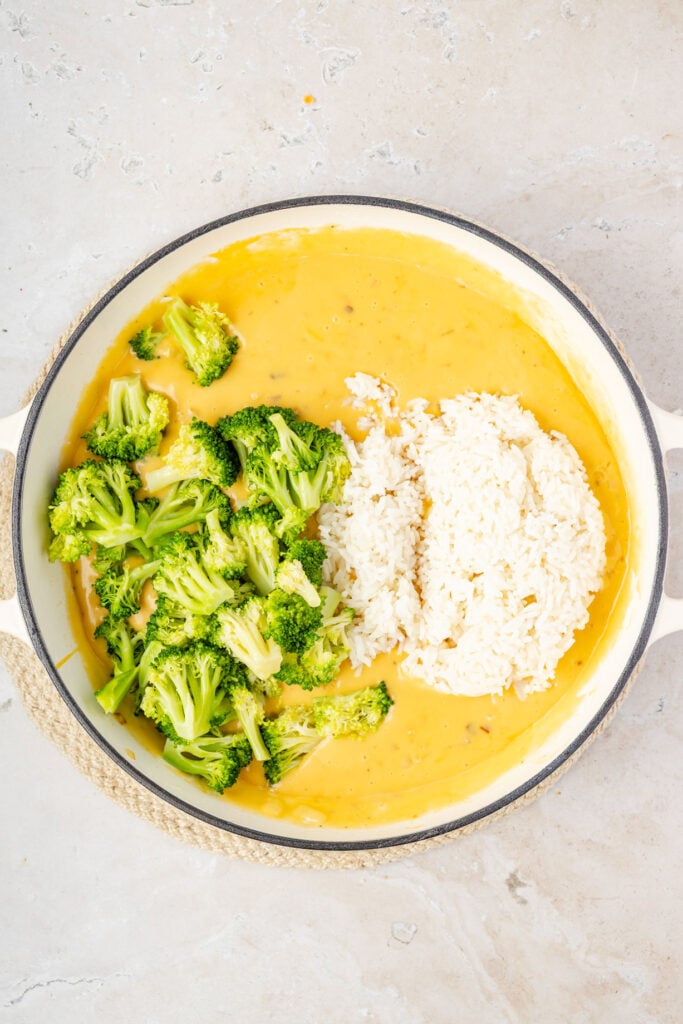 Cheese sauce, rice, broccoli in a pan
