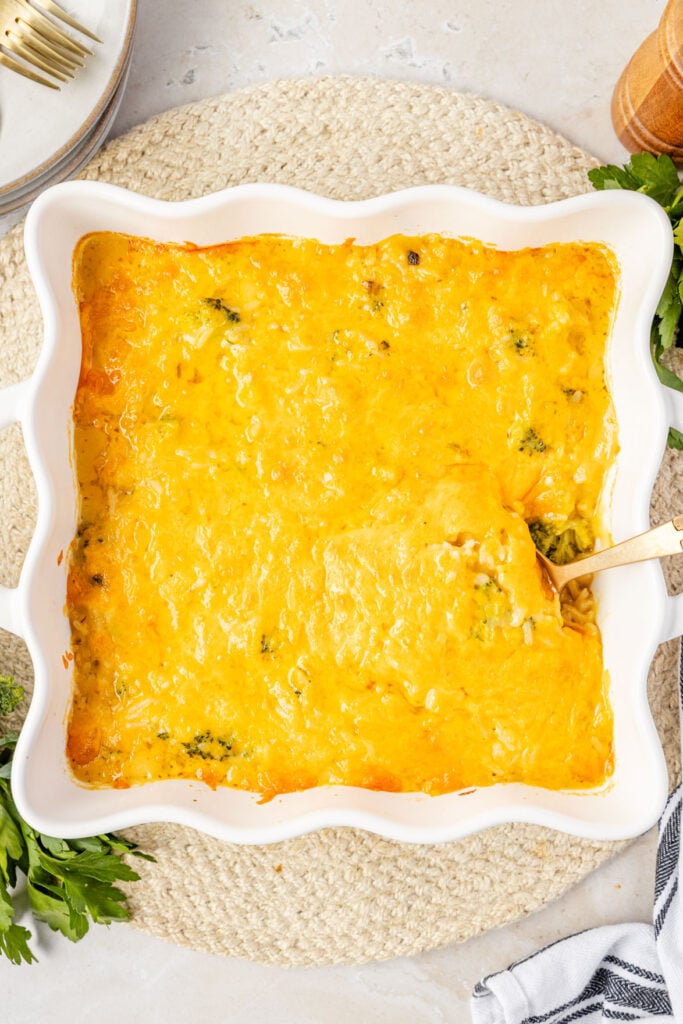 Broccoli rice casserole in a pan with a spoon