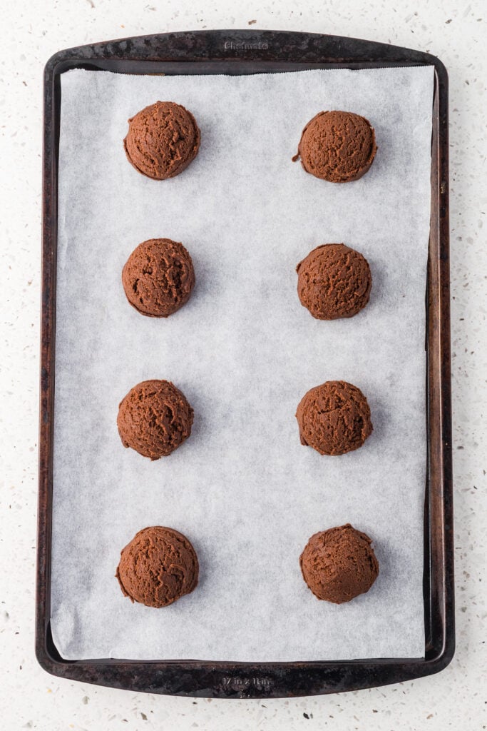Scooped cookies on a sheet pan