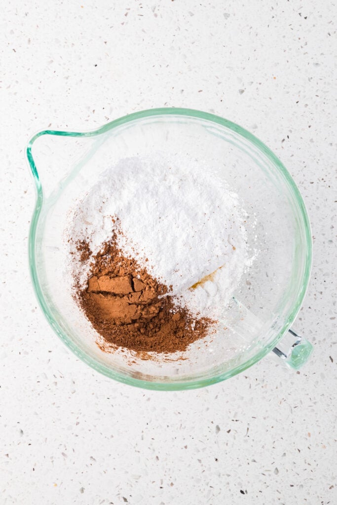 Cocoa powder and powdered sugar in a mixing bowl