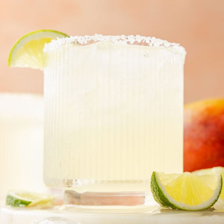 Mango Margarita with a lime on a piece of marble with mangos