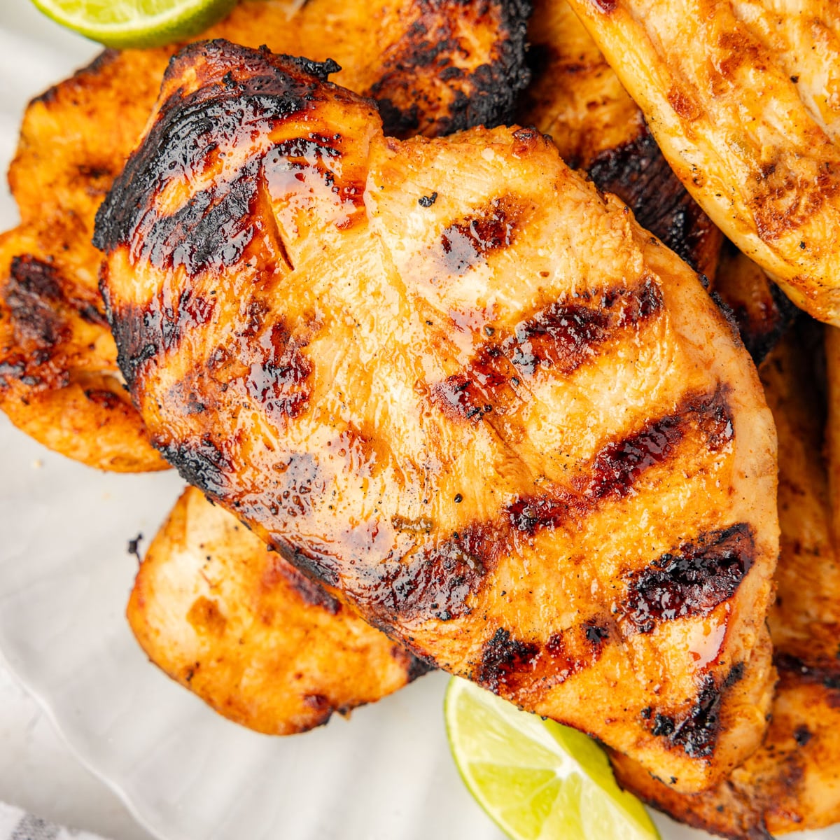 Tequila lime chicken on a plate with limes