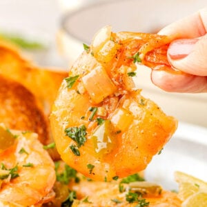 Hand picking up BBQ Shrimp