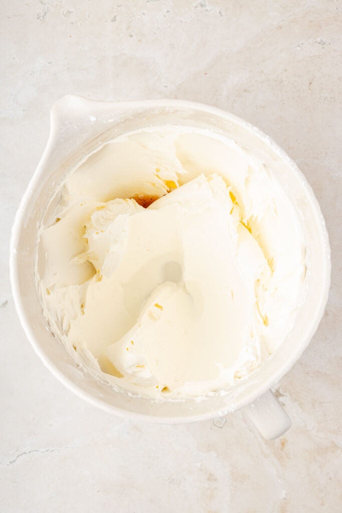 Powdered sugar incorporated into butter and sugar with vanilla and water on top.