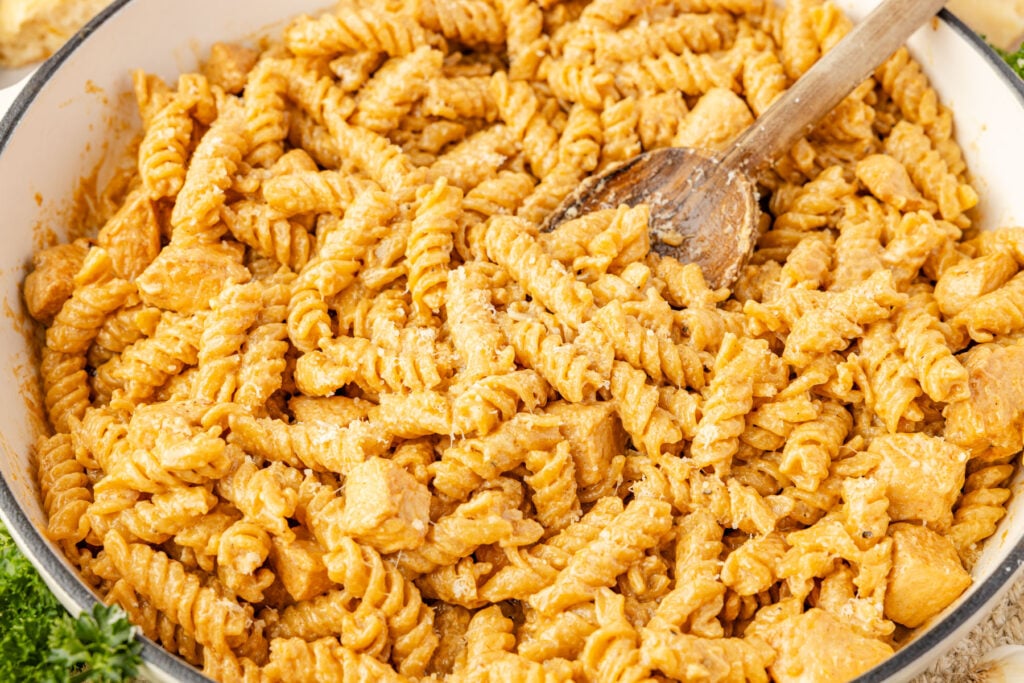 Creamy Chicken and Garlic Pasta close up with a wooden spoon