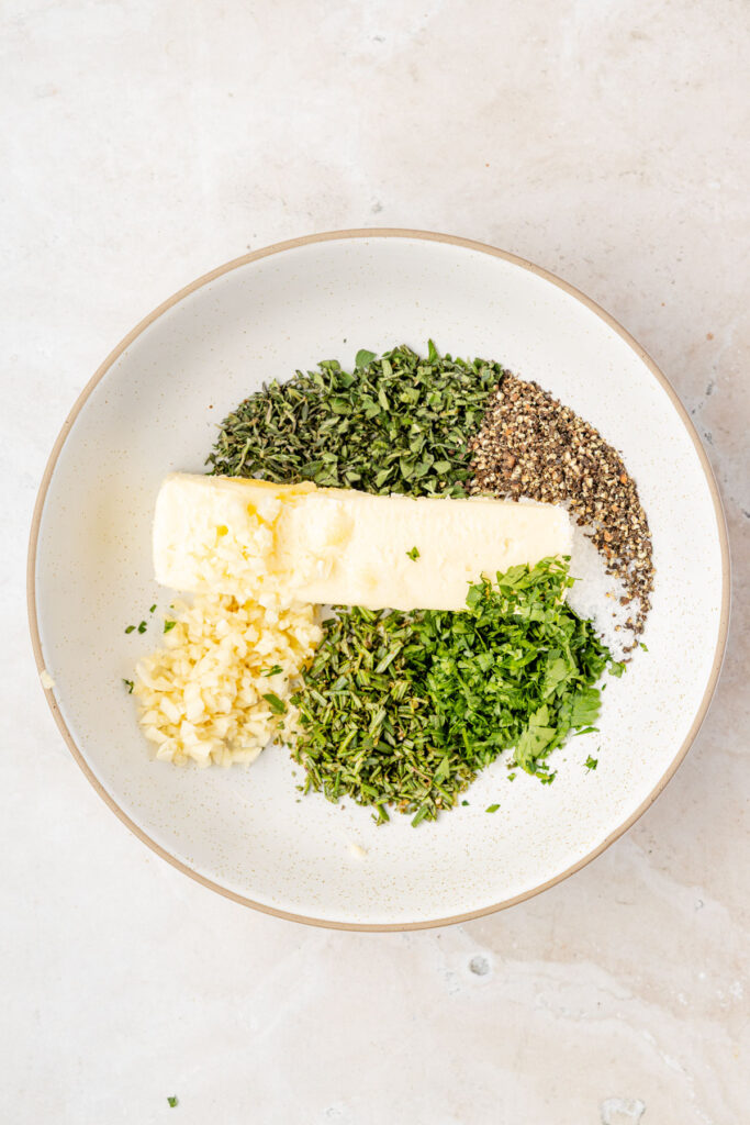 herbs, butter, herbs and spices in a bowl