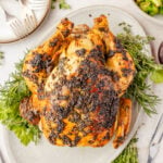 Herb Roasted Chicken on a plater with fresh herbs