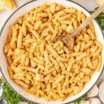 Creamy Chicken and Garlic Pasta in a pan wiht a wooden spoon