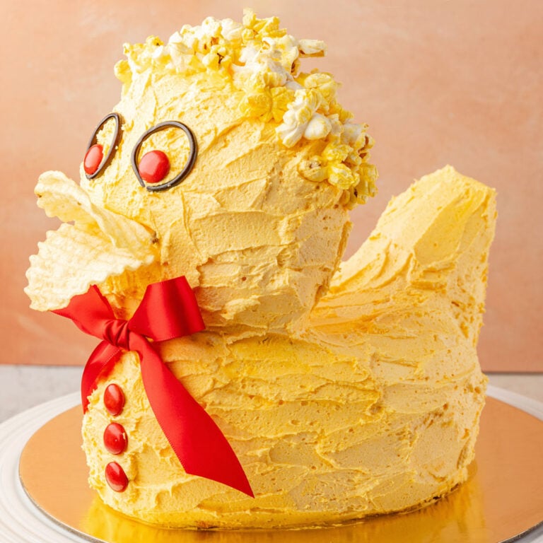 Finished duck cake on a gold board.