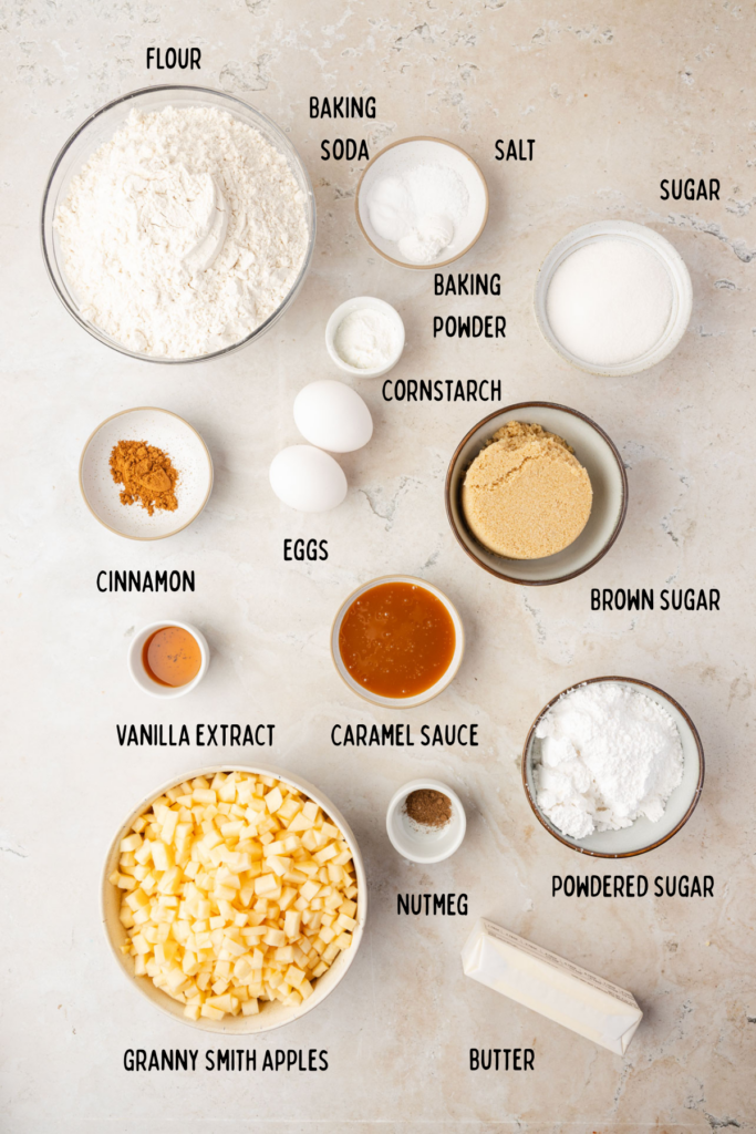 Ingredients for apple pie cookies, and small bowls on a stone background.