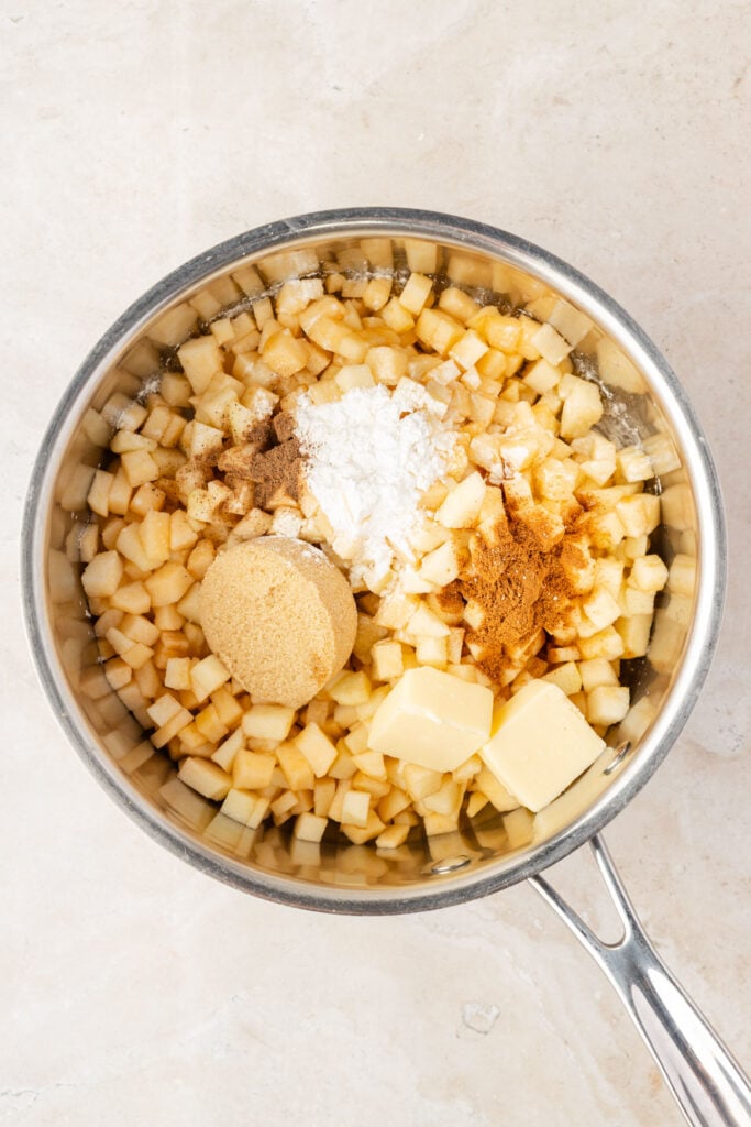 Diced apples, sugar, spices, and butter in a pan