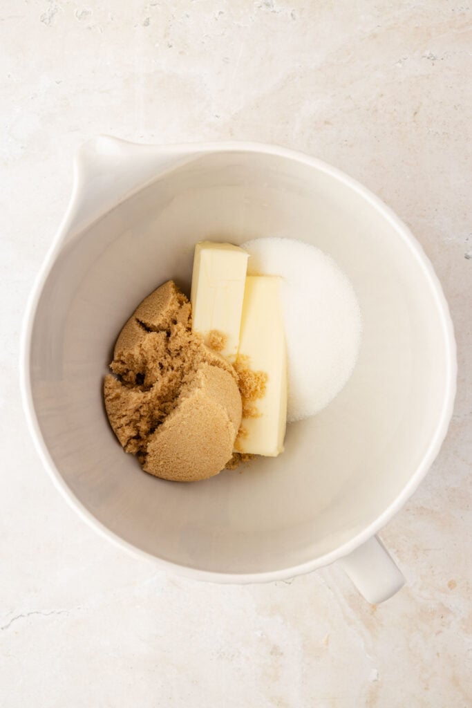Brown sugar, granulated, sugar, and butter in a mixing bowl