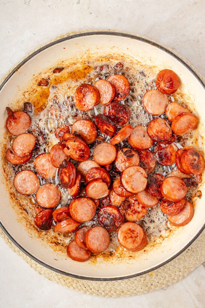 cooked sausage and bacon in a pan