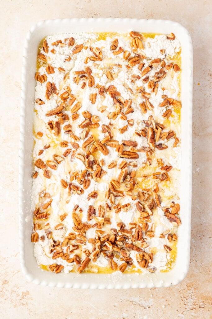 Raw Pumpkin Crunch Cake in a 9 x 13 casserole pan on a stone surface