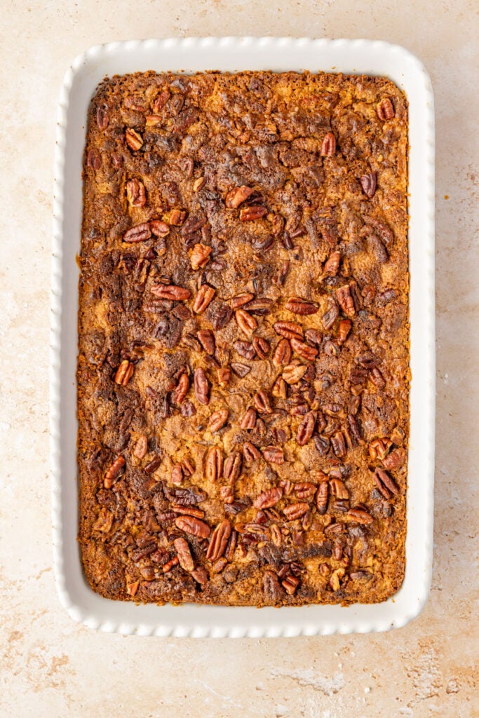 Finished Pumpkin Crunch Cake in a 9 x 13 casserole pan on a stone surface