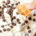Cannoli Dip being scooped by a waffle cone