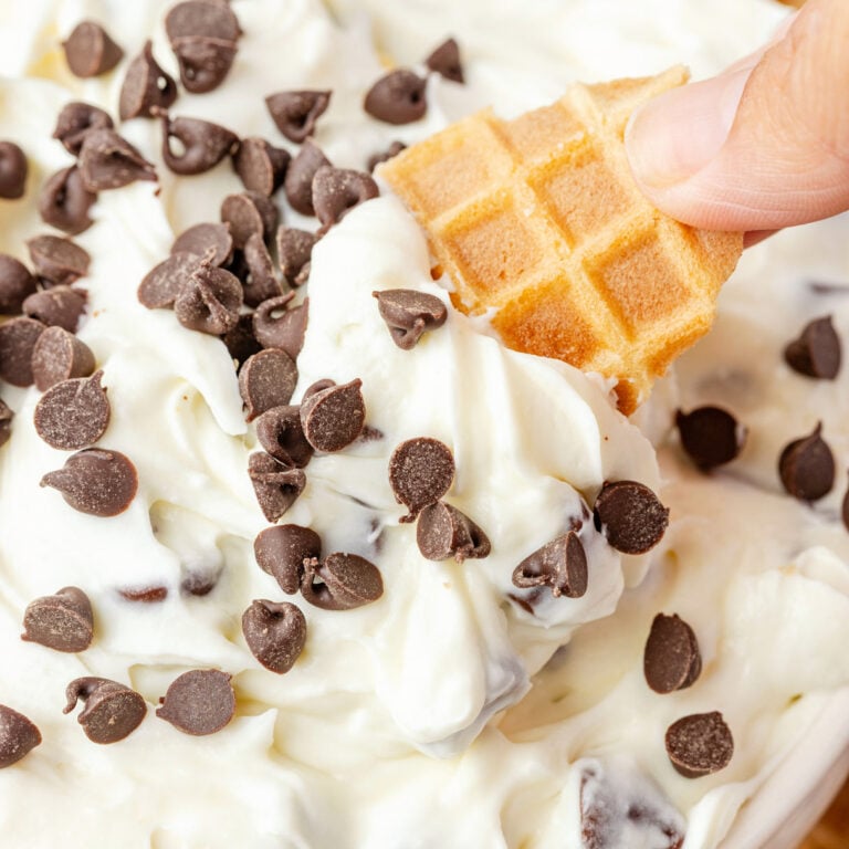 Cannoli Dip being scooped by a waffle cone