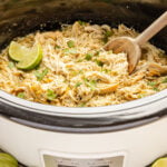 Slow Cooker Salsa Verde Chicken in slow cooker with spoon.