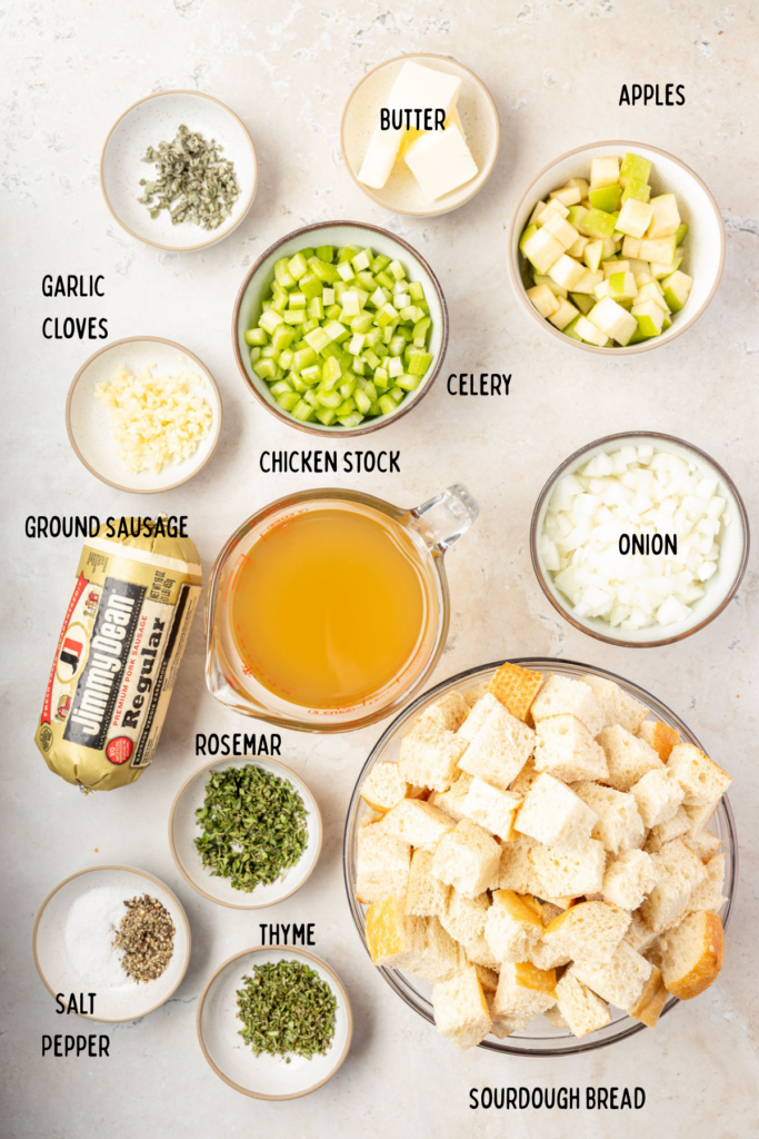 All the ingredients to make apple sausage, stuffing, and small mixing bowls