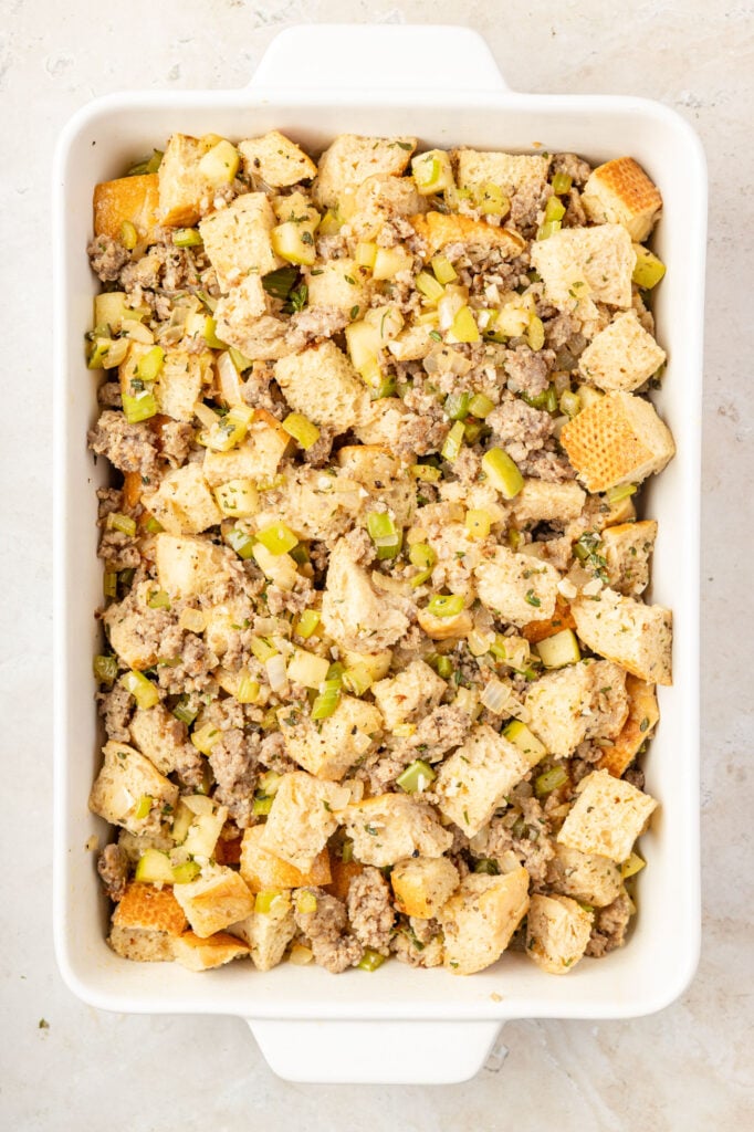 Raw apple sausage stuffing in a casserole pan