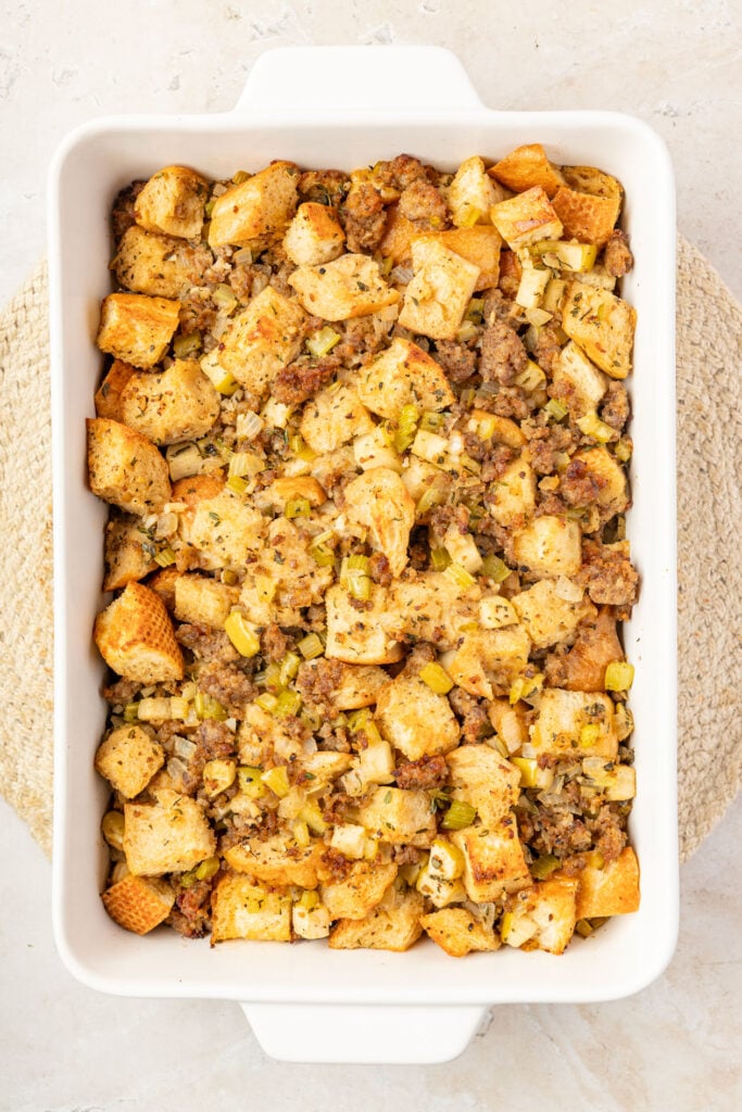 Finished apples, sausage stuffing in a casserole pan