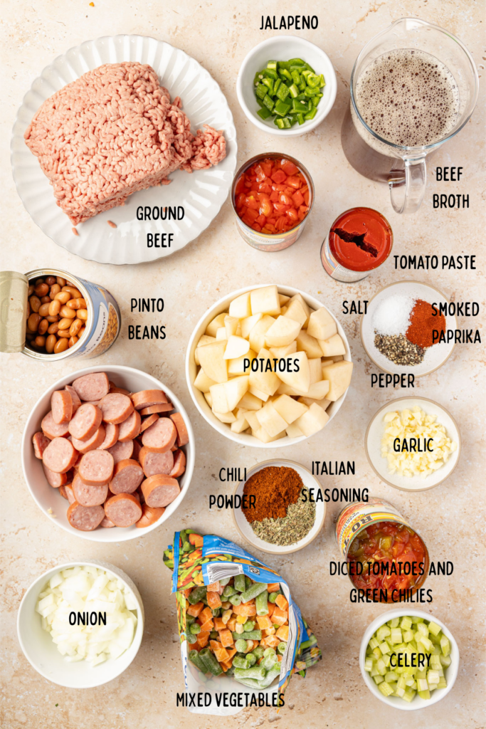 All the ingredients in individual bowls or plates on a surface for cowboy stew