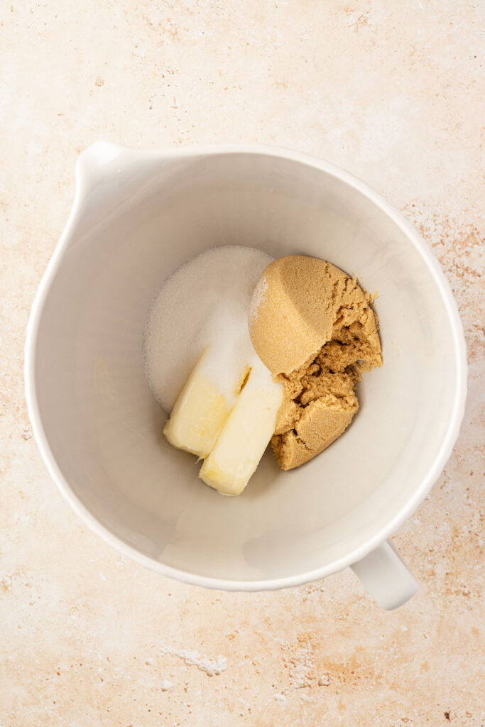 Granulated sugar, brown sugar, and butter in a mixing bowl.
