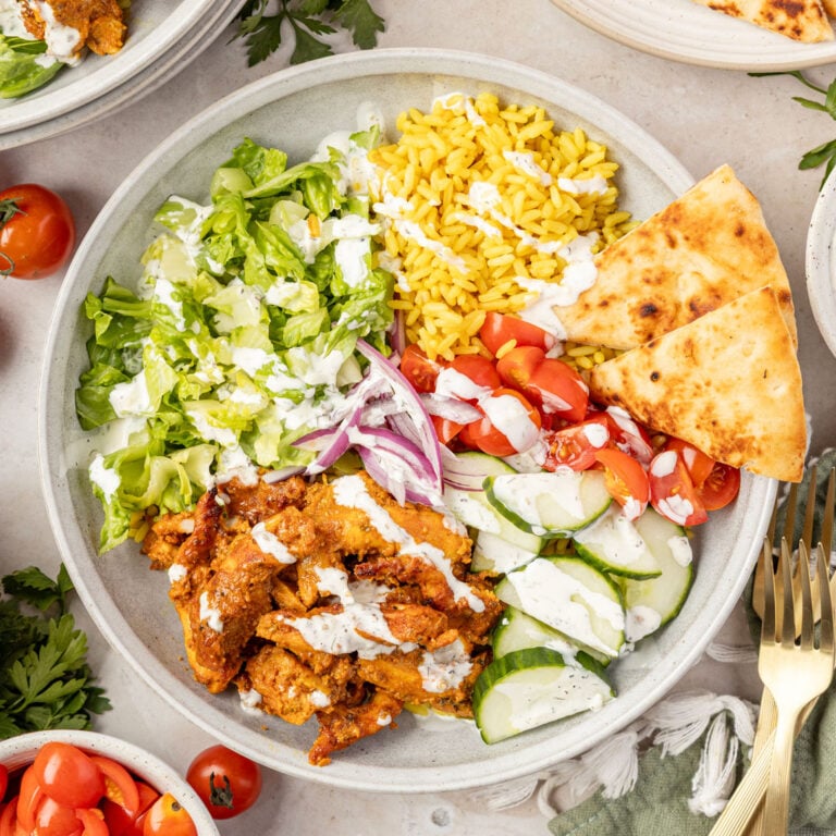 Chicken Shawarma Bowl with fresh vegetables around it.