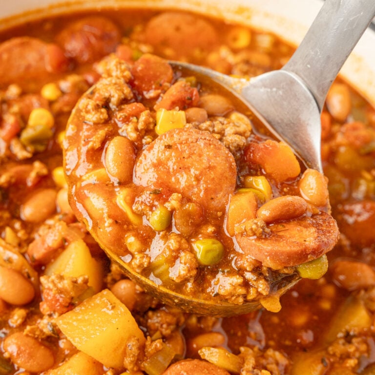 Cowboy Stew in a pot with a little scooping up some.