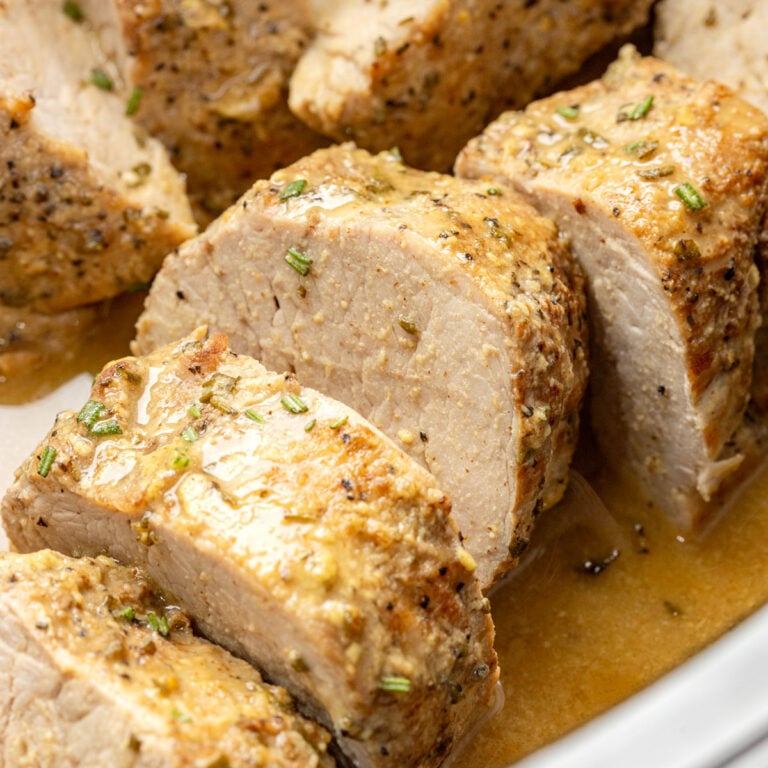 Slow Cooker Pork Tenderloin with Maple Dijon Sauce close up in a slow cooker.