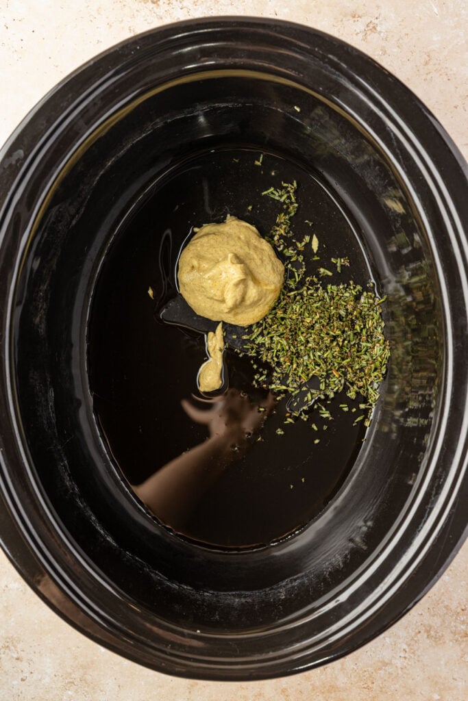Mustard, rosemary, maple syrup in a slow cooker