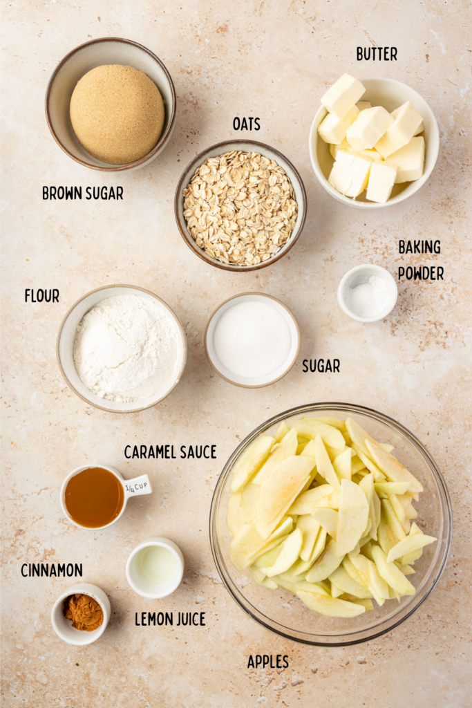 All the ingredients for apple pie bars in Little individual bowls on a stone surface.