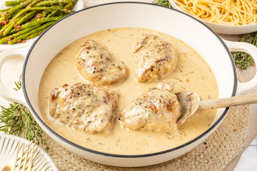 Chicken Au Poivre in a skillet with cream sauce.
