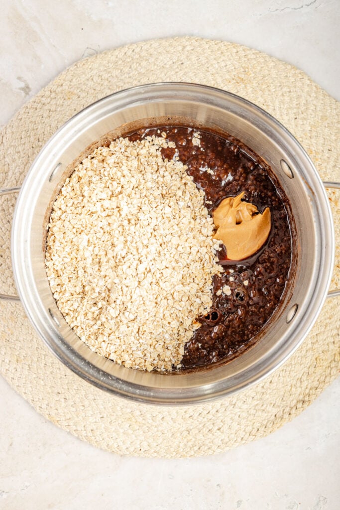 Pot filled with no bake cookie batter with peanut butter and oats