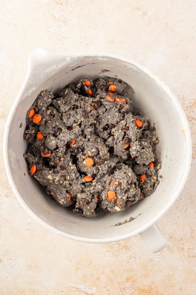 Mixing bowl filled with finished Halloween Monster Cookie batter.