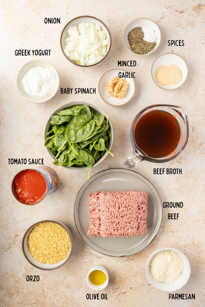 Ingredients for One Pot Beef Orzo an individual bowls on a stone surface.